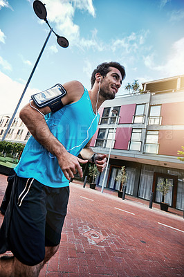Buy stock photo High angle shot of a handsome young man working out in the city