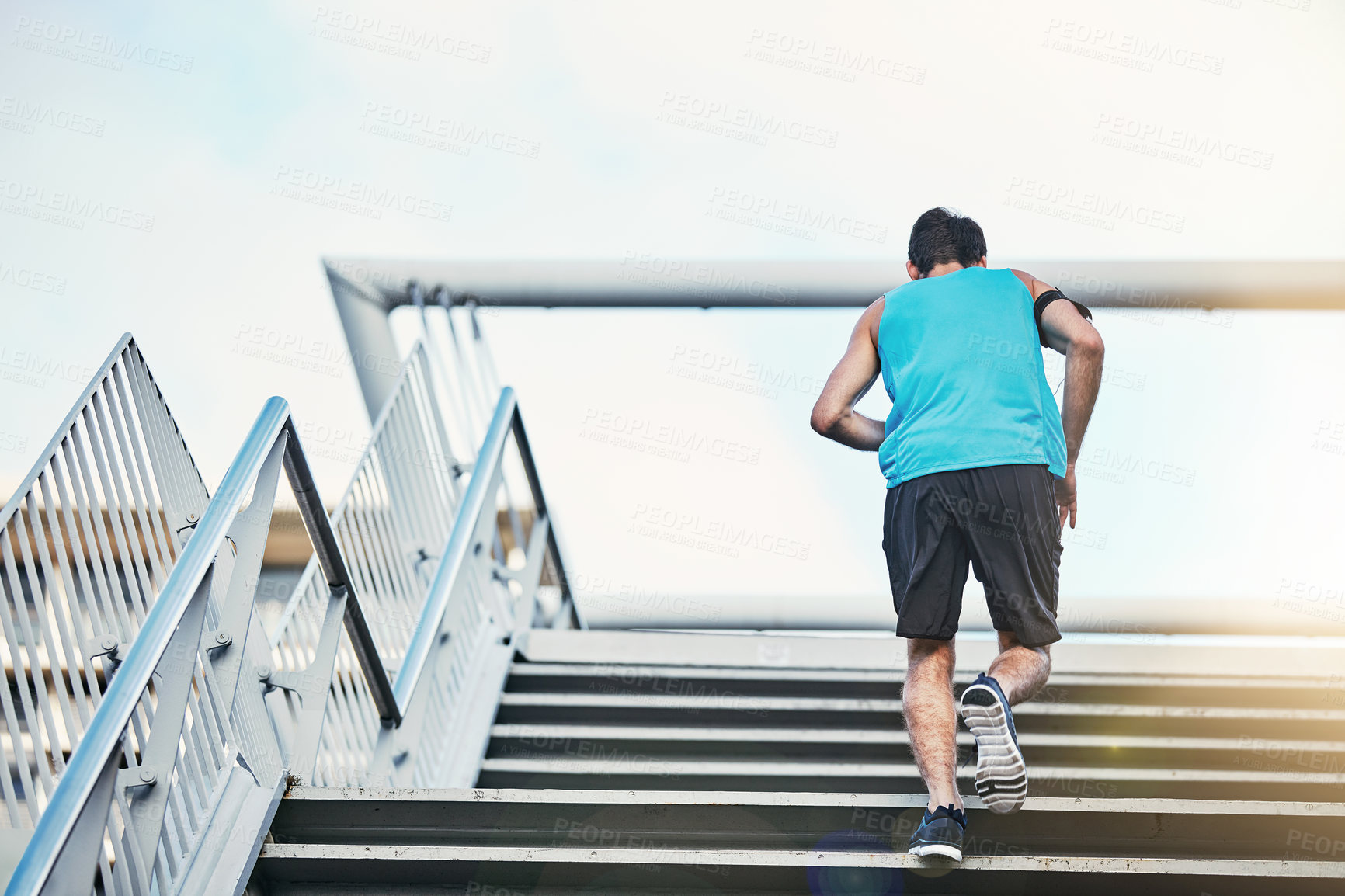 Buy stock photo Back, training and running with man, stairs and exercise with progress, sunshine and challenge. Sports, steps and runner in city, lens flare or workout for wellness, healthy or energy with fitness