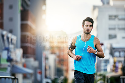 Buy stock photo Cropped shot of a handsome young man working out in the city