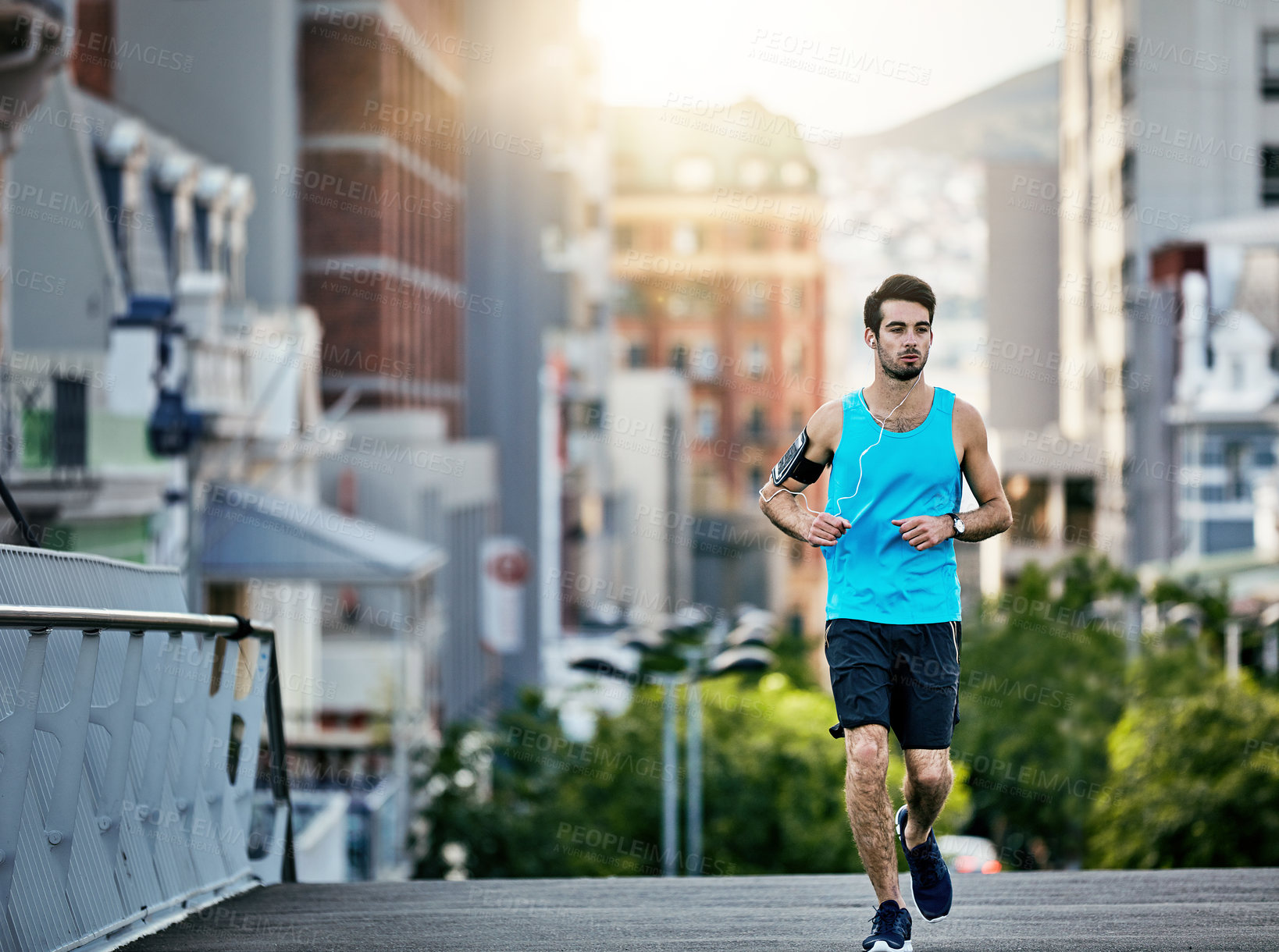 Buy stock photo Cropped shot of a handsome young man working out in the city