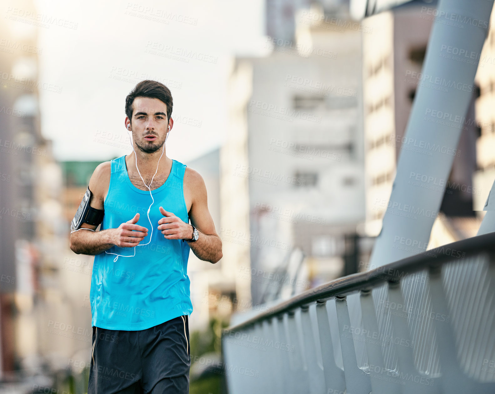 Buy stock photo Cropped shot of a handsome young man working out in the city