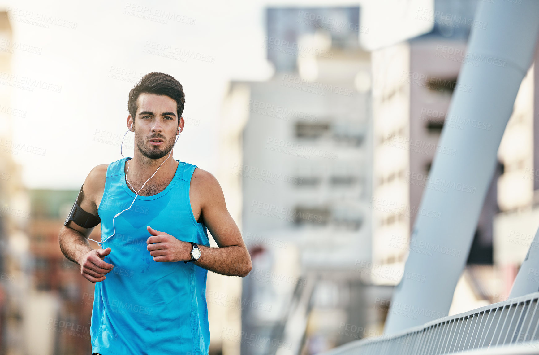 Buy stock photo Cropped shot of a handsome young man working out in the city