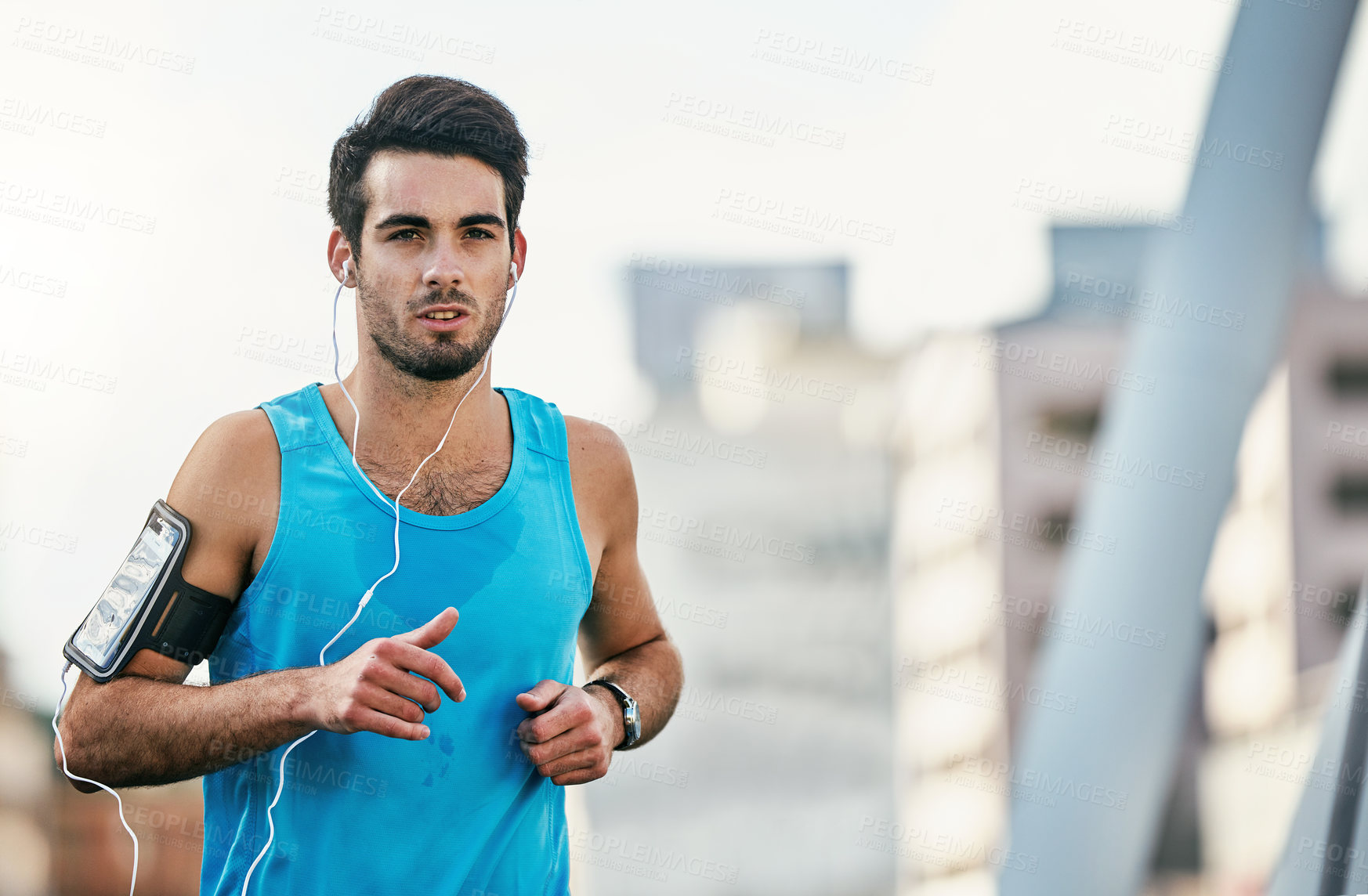 Buy stock photo Cropped shot of a handsome young man working out in the city