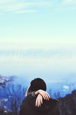 Buy stock photo Shot of an affectionate young couple enjoying a hike in the mountains