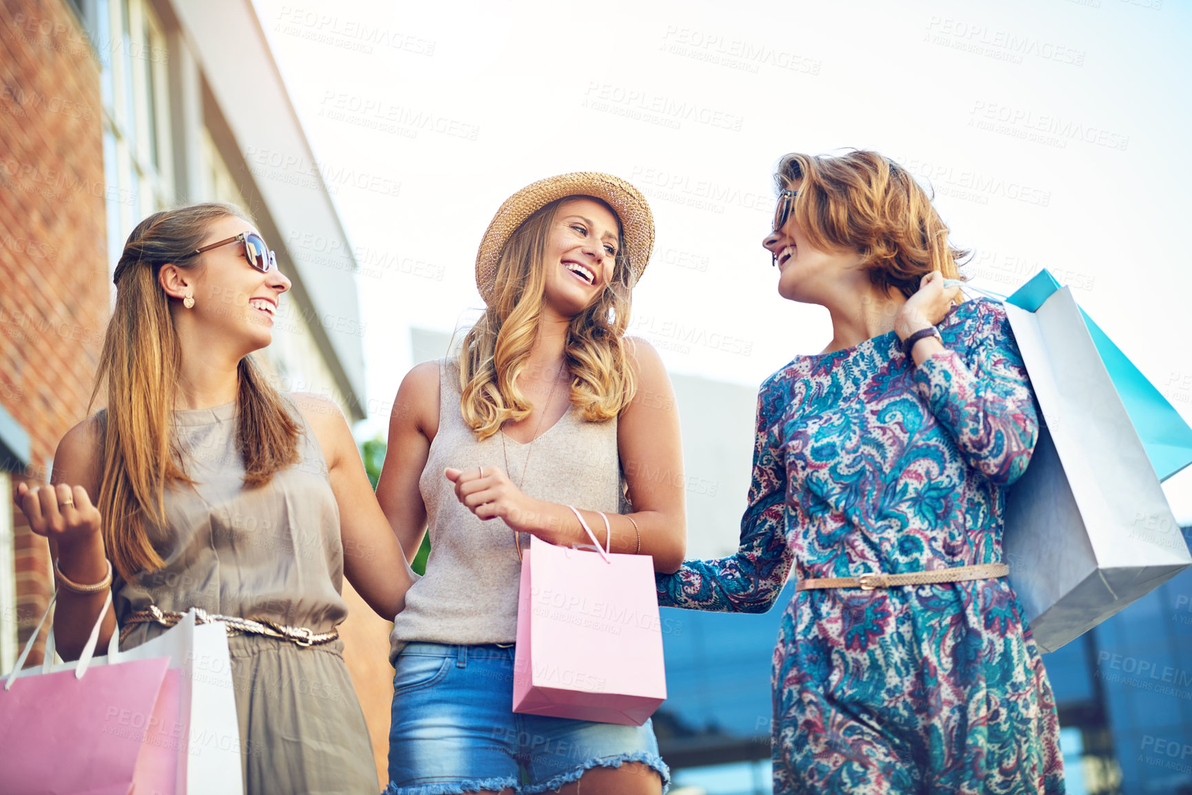 Buy stock photo Shopping, group and women in city for discount, boutique sale and happiness by mall. Girl friends, laughing and walking with paper bags for memories, reunion and commerce together for bonding