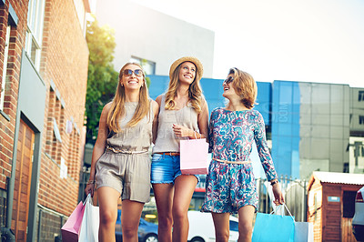 Buy stock photo Cropped shot of three young girlfriends shopping in the city center