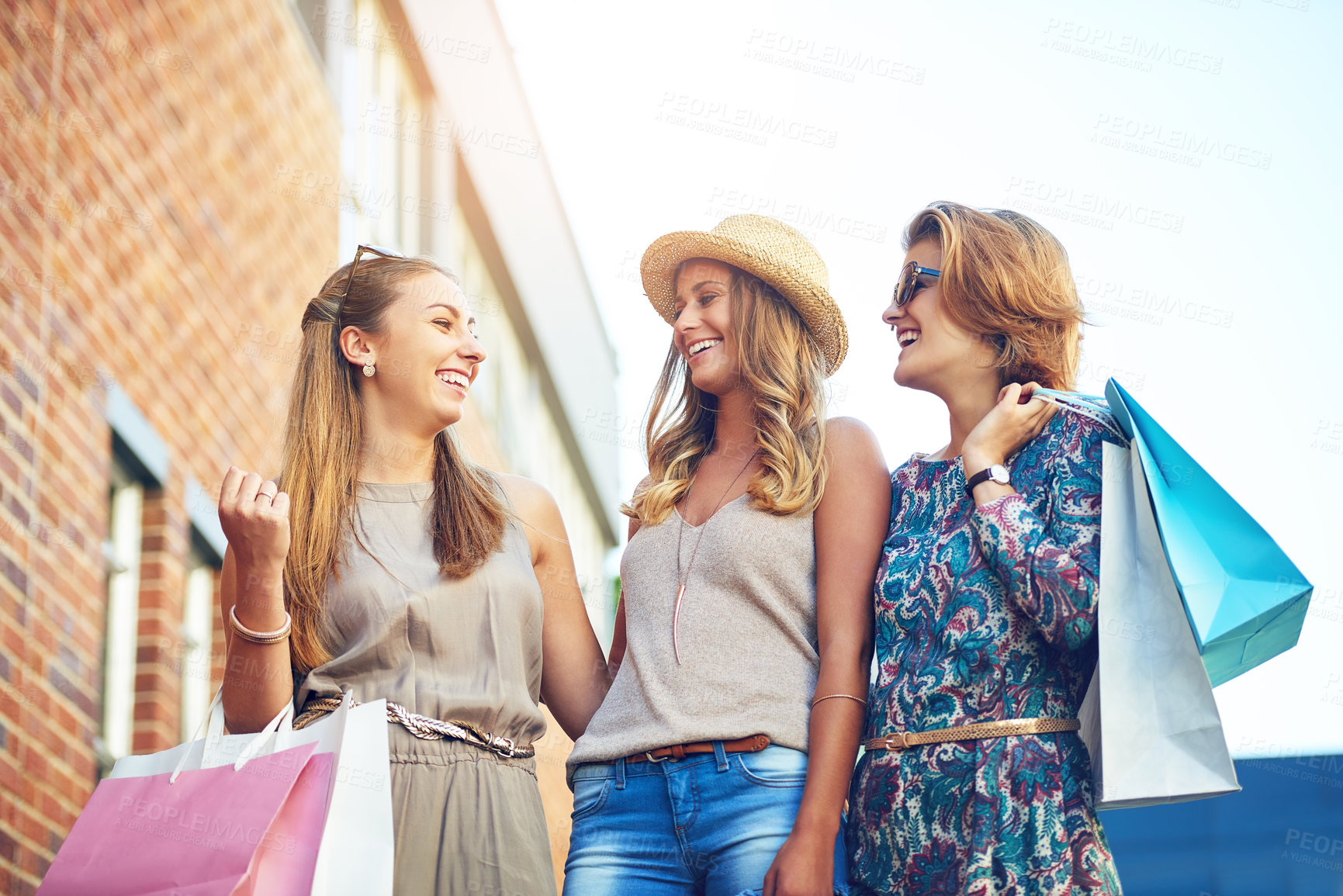 Buy stock photo Cropped shot of three young girlfriends shopping in the city center