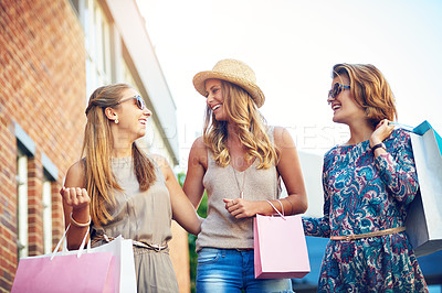 Buy stock photo Cropped shot of three young girlfriends shopping in the city center