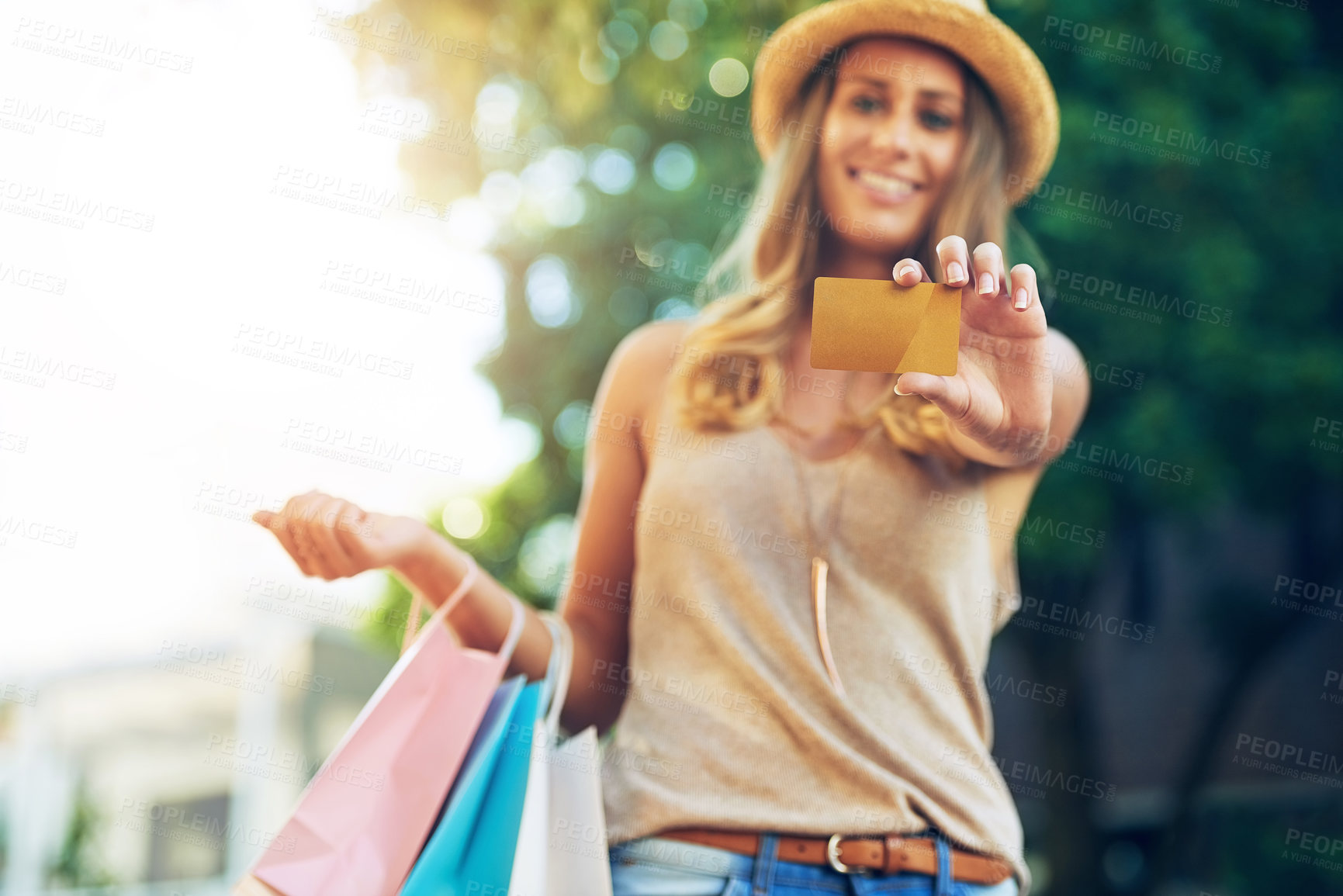 Buy stock photo Portrait of an attractive young woman showing you her credit card