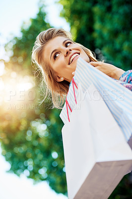 Buy stock photo Cropped shot of an attractive young woman enjoying a day of shopping
