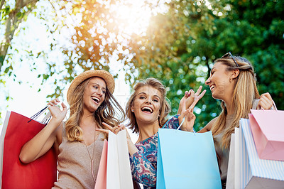 Buy stock photo Cropped portrait of three young girlfriends shopping in the city center