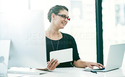 Buy stock photo Shot of a young businesswoman working at her desk in an office