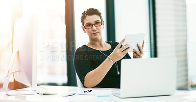 Buy stock photo Portrait of a young businesswoman working at her desk in an office