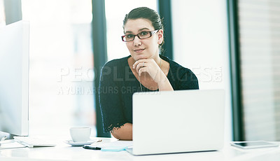 Buy stock photo Portrait of a young businesswoman working at her desk in an office