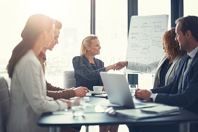 Buy stock photo Shot of a two corporate colleagues shaking hands during a boardroom meeting