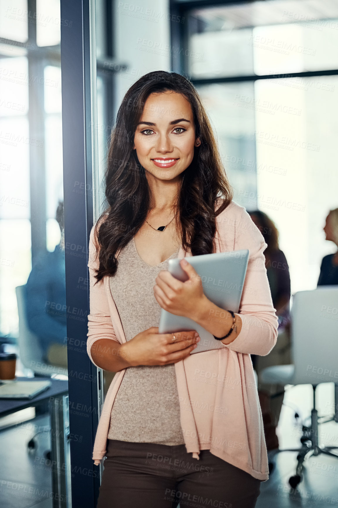 Buy stock photo Portrait of a confident young businesswoman using a digital tablet in an office