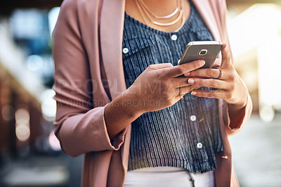 Buy stock photo Cropped shot of a young woman using her cellphone