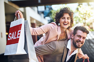 Buy stock photo Shot of a playful couple out on a shopping spree