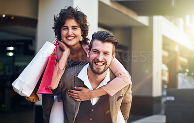 Buy stock photo Shot of a playful couple out on a shopping spree