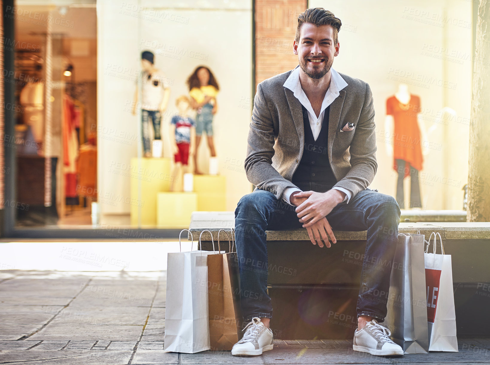 Buy stock photo Shot of a man sitting on a bench with his shopping bags on the floor