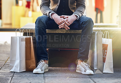 Buy stock photo City, man sitting and sale with shopping bags on floor, sidewalk or street with sneakers, relax or waiting for taxi. Guy, retail and fashion on bench in metro cbd with discount, promotion or clothes