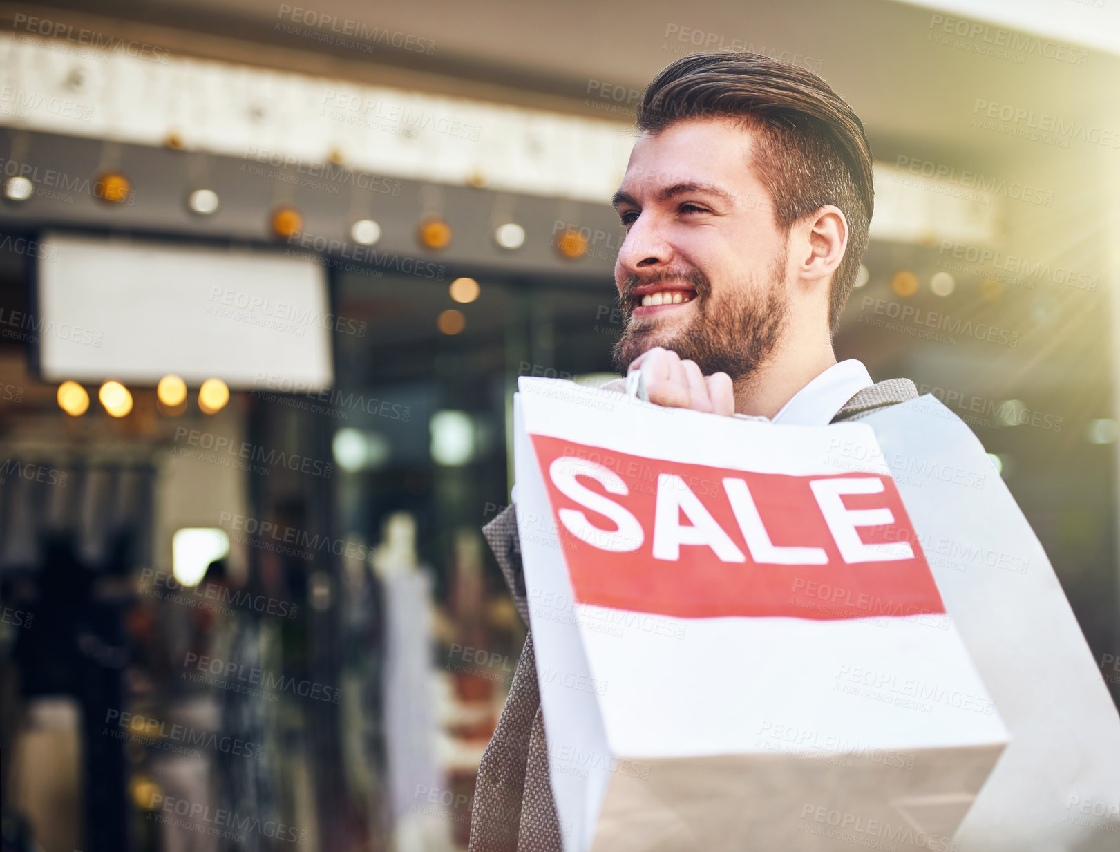 Buy stock photo Cropped shot of a young man holding a shopping bag