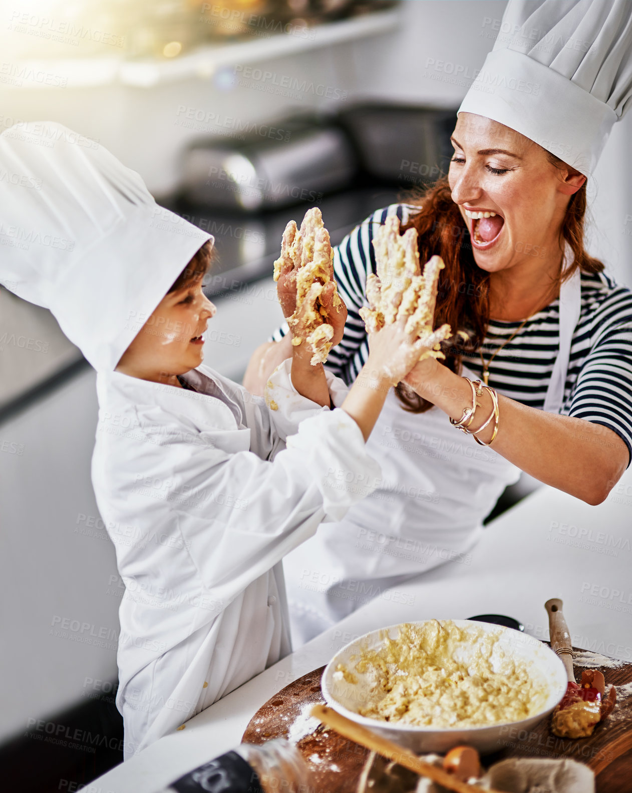 Buy stock photo Shot of a mother and her son baking in the kitchen
