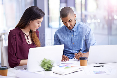 Buy stock photo Cropped shot of two young designers brainstorming together in an office