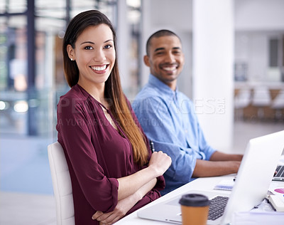 Buy stock photo Portrait of a young designer sitting an office with her colleague in the background