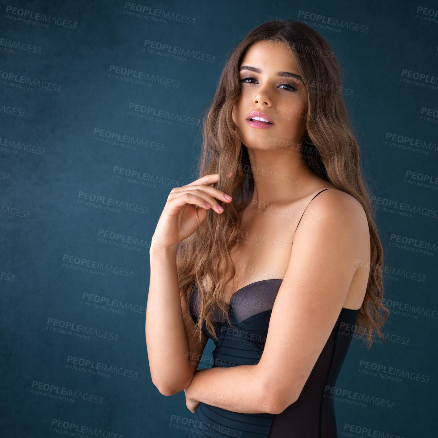 Buy stock photo Studio portrait of an attractive young woman posing in lingerie against a dark background