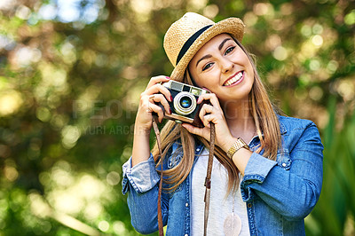 Buy stock photo Portrait of an attractive young woman taking photographs outside