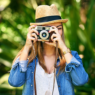 Buy stock photo Shot of an attractive young woman taking photographs outside
