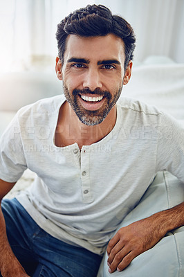 Buy stock photo Indian man, portrait and happy or relax on sofa with confidence, comfortable and weekend break. Person, laughing and funny in living room of house for me time, rest and peaceful leisure in apartment