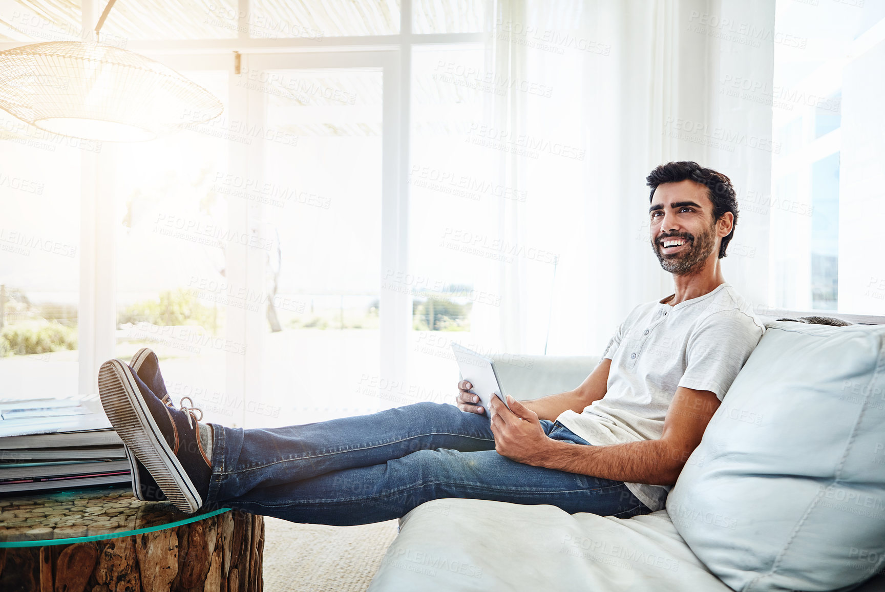 Buy stock photo Thinking, man and tablet on sofa for chat, networking and online conversation at home. Living room, male chatter and mobile app for streaming movies, games and social media with technology to relax