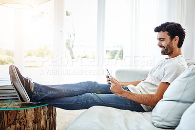 Buy stock photo Home, man and tablet on couch for networking, chat and online conversation with contact. Living room, male person and digital app for streaming movies, games and social media with technology to relax