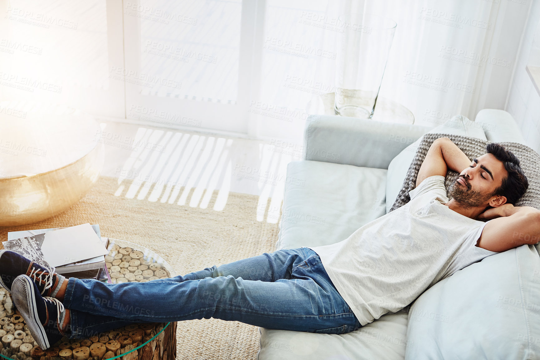 Buy stock photo Relax, man and sleeping on sofa for resting, peaceful and weekend break in living room. Leisure, lazy Sunday and male person with arms out on couch for lying, dreaming or chill day off in home