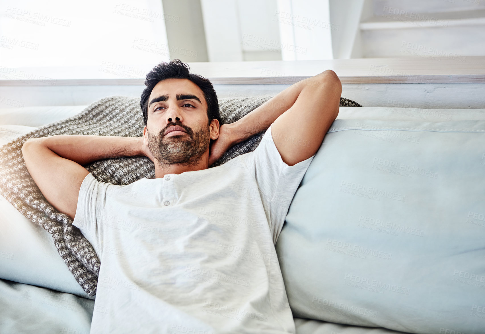 Buy stock photo Lying, relax and man on sofa for leisure, peaceful and weekend break in living room. Lazy Saturday, calm and male person with arms out on couch for cozy, comfortable rest or chill day off in home