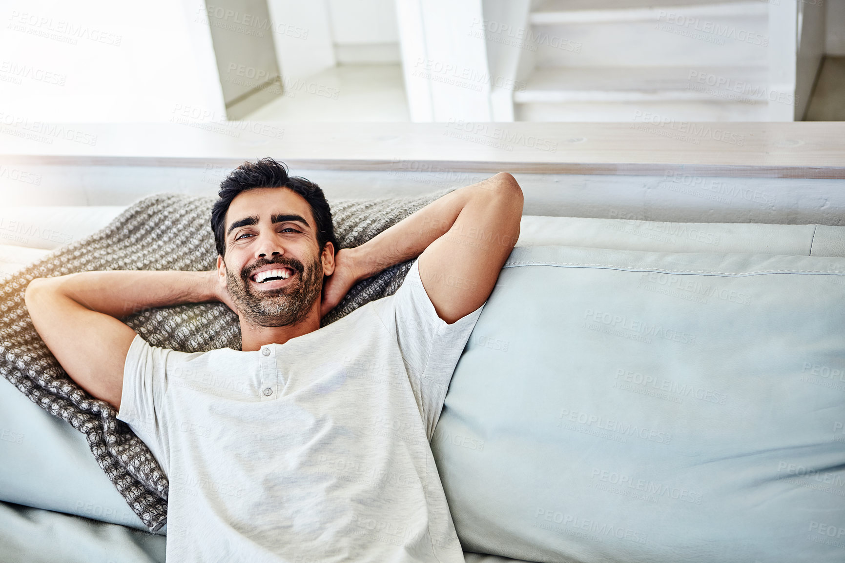 Buy stock photo Happy man, relax and lying on sofa for satisfaction, peaceful and weekend break in living room. Leisure, calm and male person with arms out on couch for lazy Sunday, comfortable or day off in home