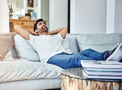 Buy stock photo Shot of a man relaxing on the sofa at home