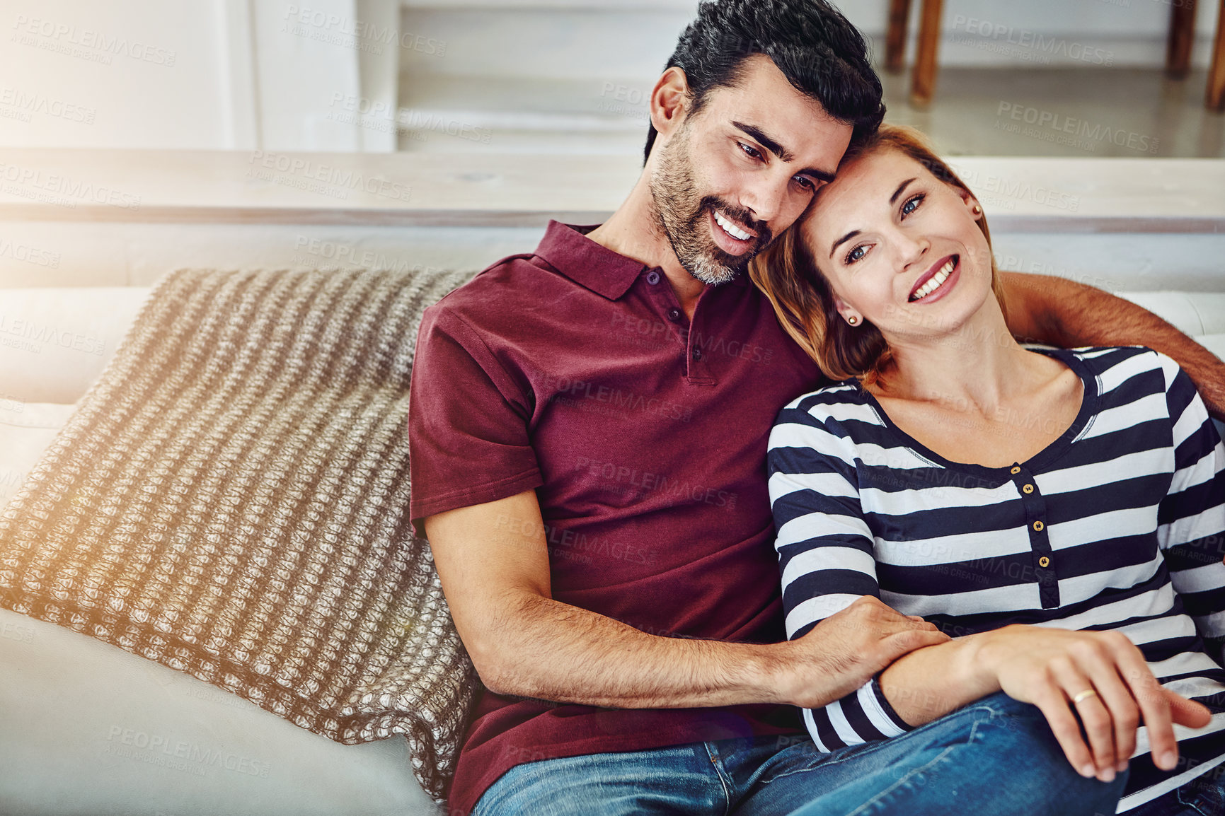 Buy stock photo High angle shot of an affectionate young couple relaxing on the sofa at home