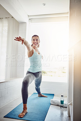 Buy stock photo Shot of an attractive woman practising her yoga routine at home