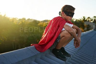 Buy stock photo Shot of a young boy in a cape and mask playing superhero outside