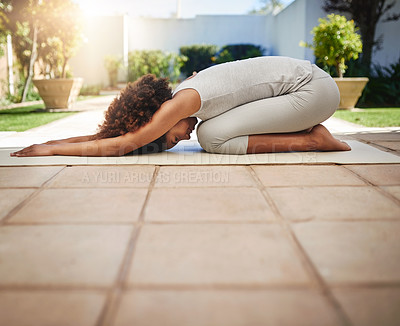 Buy stock photo Full length shot of a sporty young woman practicing yoga outdoors