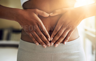 Buy stock photo Hands of woman on stomach, diet and fitness for gut health and lipo wellness for body positivity. Gym, healthcare and tummy tuck, girl model with heart hand sign on abdomen for muscle exercise goals.