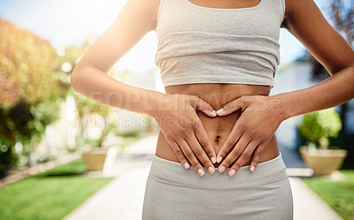 Buy stock photo Hands of woman on stomach in park, gut health and fitness for lipo wellness for body target for balance. Gym, healthcare and tummy tuck, model with heart hand sign on belly for muscle exercise goals.