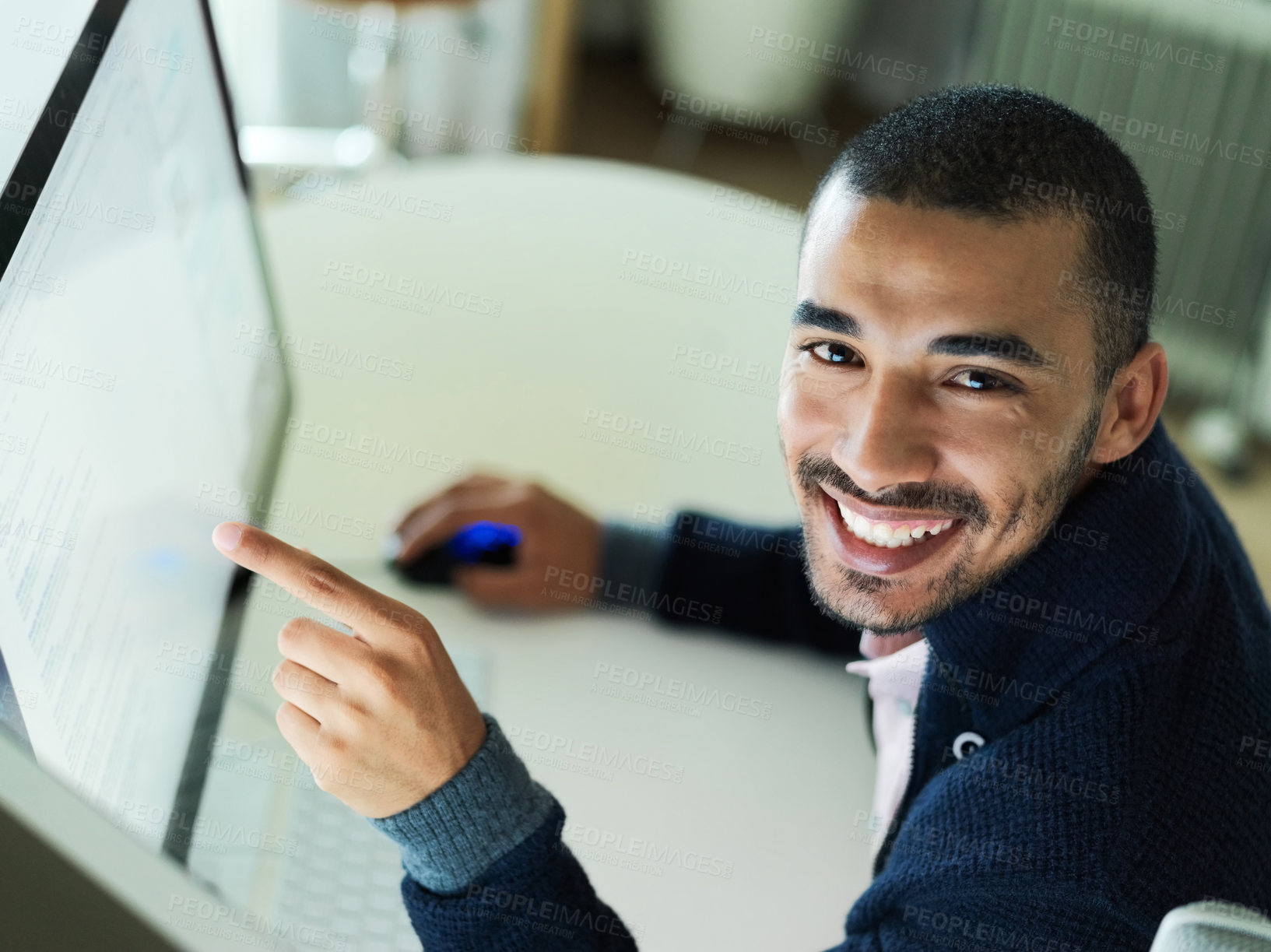 Buy stock photo Portrait of a smiling young man sitting at a desk working on a computer with dual monitors