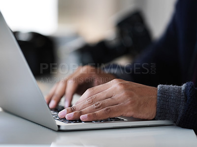 Buy stock photo Cropped closeup shot of an unrecognizable photographer sitting at a table using a laptop