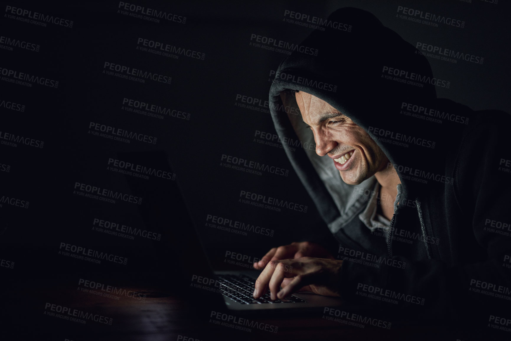 Buy stock photo Dark, basement and man at laptop for hacking, online programming and cybersecurity at night. Software, developer or hacker in hoodie coding for password, firewall or network access for cyber attack