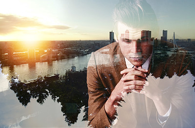 Buy stock photo Shot of a focused young businessman superimposed over a cityscape