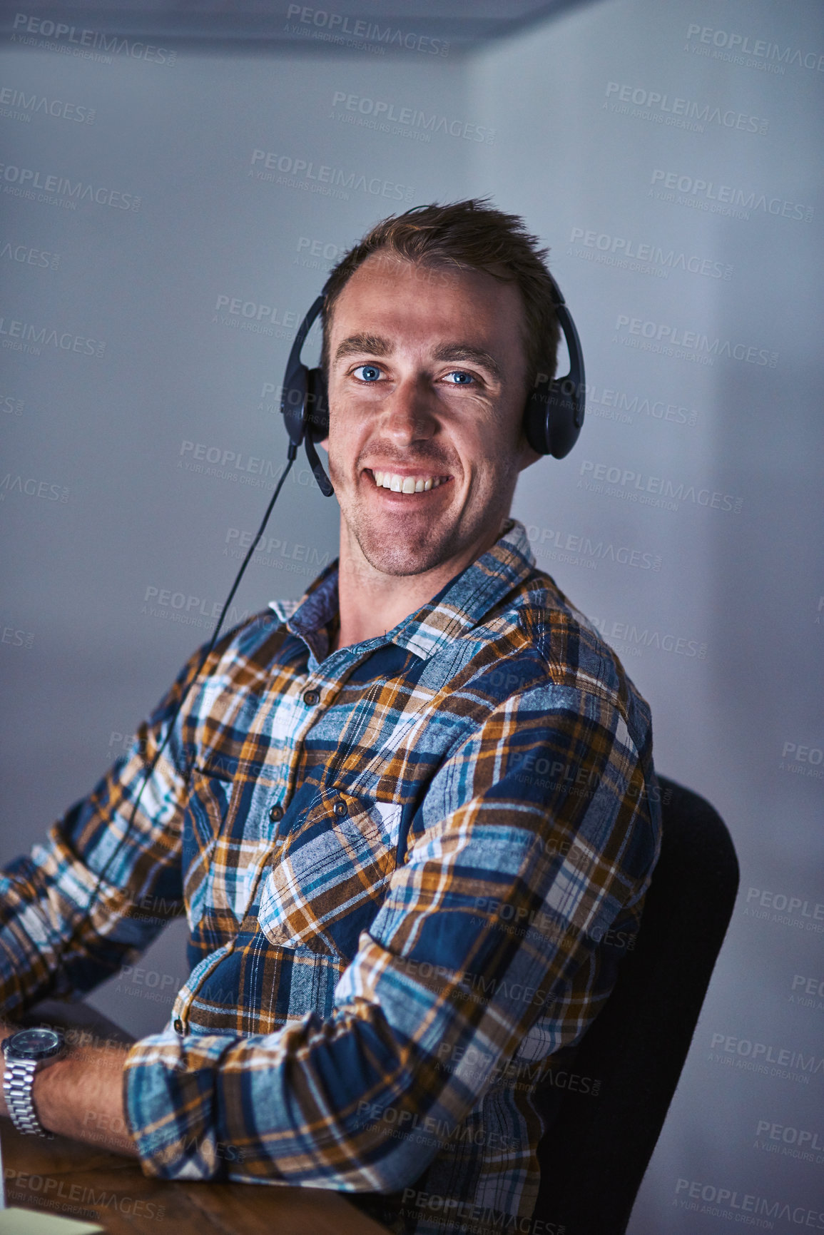 Buy stock photo Portrait of a happy customer service agent wearing a headset while sitting in the office